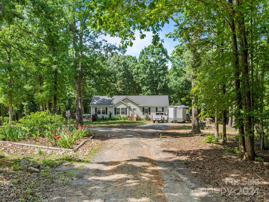 The privacy and natural surroundings you have been looking for is abundant in this fantastic modular on almost 10 acres!  The seclusion of this property is evident from the moment you travel down the tree-lined gravel drive.  There is plenty of room to park your vehicles as well as an RV.  Inside boasts an open floorplan with a sizable primary suite and eat-in kitchen, perfect for entertaining.  Kitchen also features reverse osmosis filtration system at the kitchen sink. The outdoors are where the real magic happens. The back deck invites you to sit and listen to the wind blow through the trees and the chirping of the birds. Plenty of acreage to improve or leave natural as you see fit.  Chicken coops are already on the property. This property is a true gem on its own and is also close to lake amenities as well as a golf course.