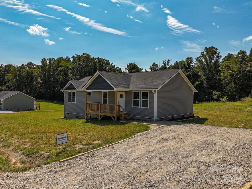 Bellflower Meadows is a 16 lot subdivision in the heart of Apple Country. Minutes to your favorite fall hay ride and apple picking. Less than 10 minutes to grocery stores and restaurants and only 15 minutes from downtown Hendersonville. Big flat yard! Open floor plan bathed with warm natural light is perfect for entertaining. Roomy primary bedroom boasts a large walk-in closet and primary bath with dual vanity and custom tile shower. Luxury vinyl plank flooring, fabulous kitchen with stainless steel appliances, granite counters, spacious all-plywood soft close cabinets, under cabinet lighting, and the perfect kitchen island. Neutral colors make decorating a breeze. A spectacular place to enjoy that clean mountain air. Well-priced, move-in ready and waiting hold all of your fond memories or become your next charming retreat or sought after investment property. Finished interior pictures are shown as an example. Tax value based on previous vacant land does not represent improvements.