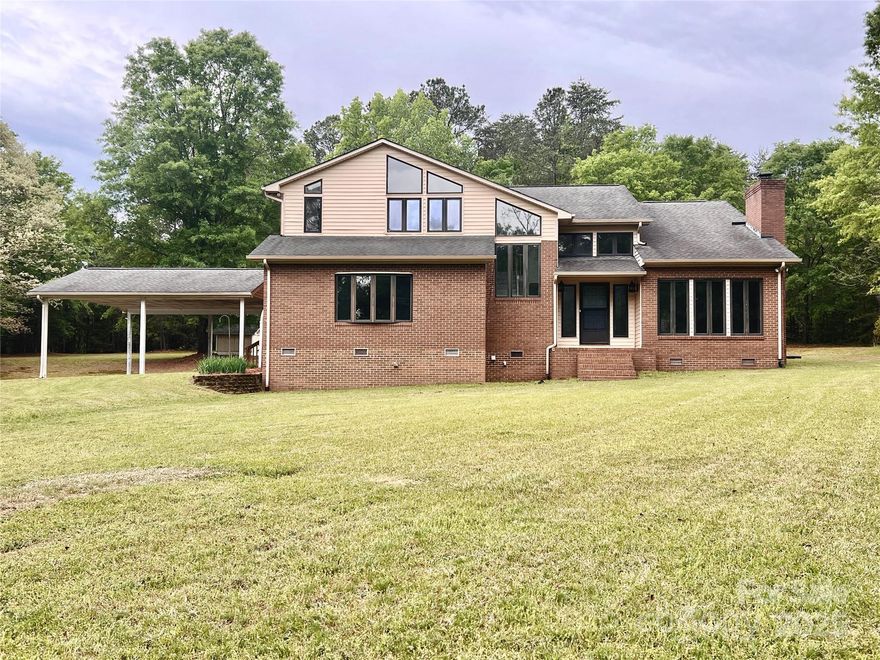 Escape... To this hidden gem in the sought-after Clover School District. 611 Stowe Road is a secluded custom home nestled on 11 beautiful acres with the ability to sub-divide!  The spacious interior boasts three well-appointed bedrooms and 2.5 bathrooms, providing ample comfort and privacy. Additionally you will find a 2 story family room, & den (each has a wood-burning fireplace), dining room AND a 500+ square foot flex room allowing you to let your creative juices run wild! (It would be perfect to convert to an in-law suite!)  Offering an abundance of natural light throughout, the property's generous size allows for various potential uses. A 30+ foot long screened rear patio w/ skylights overlooks the expansive back yard with plenty of space to add a pool, just in time for summer! With its convenient location near town amenities and the vast outdoor space, this home presents a unique opportunity for a blend of comfort, convenience, and limitless potential.