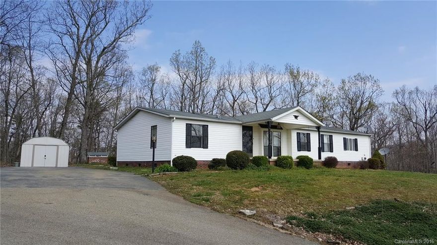 If privacy is what you are seeking, this is it!  Feel like you are on top of the world with with long range views and the glow of Charlotte in the distance.  Long right of way driveway takes you to a very private 4.8 acre parcel with nice 3 bedroom home with covered porch, living room and Family room with fireplace, large back deck and Storage building.  30 x 40 Slab in place with electric for future barn or garage plus additional location with electric, septic and shared water for another home.