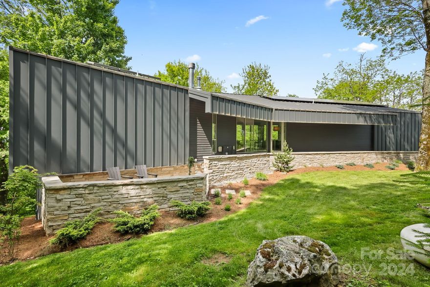Modern meets mountain at this unique property on 3+ ac w/ great yards, wooded privacy, long range views (w/ full view control), rock features, & level parking/entry. A well-thought-out floorplan w/ accordion glass doors/walls make nature the center of attention! Perfect for a getaway, investment property (ST rentals allowed), or full-time residence. This 4BR 3.5BA home, designed by award-winning architect Vincent Petrarca, offers living space & primary suites on EACH of its 2 floors. The great room, open to the kitchen & dining area, features accordion windows/doors that open to the Ipe deck. The main level primary suite features soaking tub, tiled shower, & double vanities. Downstairs, find a 2nd living/family room w/ patio access (w/ views!), the 2nd primary suite, 2 additional BRs, full bath, & laundry. Addt'l features: DOUBLE LOT, geothermal HVAC, radiant floor heat, solar hot water, Ipe wood deck, stone patios, covered front entry through open air garage-like carport, HS internet.