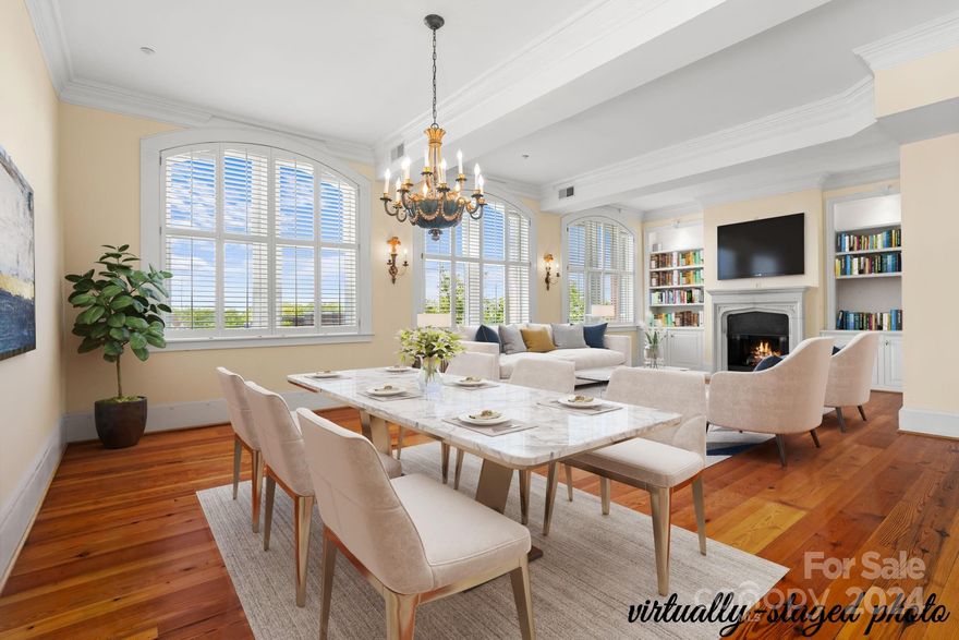 Experience luxury living in the heart of historic downtown Rock Hill! This exceptional home combines elegance & modern comfort, with a secure elevator opening directly into your condo. Captivating views & a rooftop terrace provide the perfect setting for local parades & fireworks. A private 2-car garage adds rare convenience to downtown living. The interior features soaring 12' ceilings, intricate crown molding, arched windows & rich heart-of-pine floors. The light-filled living room with a cozy fireplace & the updated gourmet kitchen are designed for both everyday use & entertaining. Retreat to the generously sized bedrooms, including a primary suite with an office with custom built-ins, luxurious whirlpool tub & tiled shower with a heat lamp. The rooftop terrace is the ultimate outdoor escape, featuring a half bath & prep sink—ideal for hosting gatherings or simply enjoying the ambiance of downtown. This exceptional home offers unparalleled style, convenience & location!