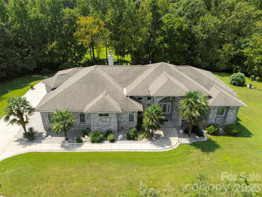 Amazing Property in this meticulously maintained full-brick custom ranch nestled on 2.3 private acres in the highly desired Weddington school district. This 5-bedroom, 4-bath home offers soaring ceilings, formal dining room, living room, family room with a fireplace and wrap around sunroom overlooking the sprawling deck with serene pond views. The spacious floor plan is perfect for entertaining with many sitting areas, a kitchen with gorgeous counters, breakfast bar and outside grilling area.  The flat yard with a fire pit and mature trees will be enjoyable for all.  Many storage areas, spacious bedrooms and oversized rear facing 3-car garage with extra parking. The 5th Bedroom is currently an office, many flex spaces and NO HOA is just an example of how this home has endless opportunities.