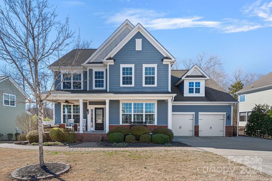 This popular Jamison model in amenity-rich Lawson is loaded with upgrades! The beautiful kitchen has abundant cabinet space, an island, gas cooktop, exhaust hood & walk-in pantry. The main level features an open floor plan with a Great Room, dining room, office and the primary bedroom. Beautiful trim details throughout the home include crown molding, wainscotting, and coffered ceilings in the kitchen and primary bedroom. Upstairs you’ll find three more bedrooms, two full baths & a bonus/5th bedroom with a movie projector and screen. Awesome laundry/mud room offers ample storage. Fantastic outdoor living area with a screened porch, open covered porch, and a large paver patio with a fireplace. Don’t miss the storage room under the porch & the tall crawl space. Refrigerator, washer and dryer are included. Custom closet in primary bedroom. Central vacuum on main level. Enjoy all of the Lawson community features -- outdoor pools, fitness centers, playgrounds, tennis courts & walking trails.