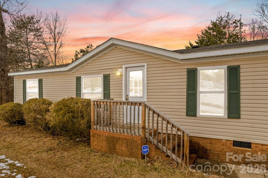 Conveniently located near I-77, shopping, restaurants, and downtown Statesville, this spacious 4-bedroom, 2-bath home offers the perfect blend of accessibility and privacy. Situated on 1.08 acres with a wooded rear backdrop, you’ll enjoy peaceful surroundings while staying close to everything you need. Step inside to a large living area that flows seamlessly into the kitchen and dining space, creating an ideal layout for everyday living and entertaining. The kitchen features abundant cabinetry and generous prep space for cooking and gathering. The primary suite includes a large closet and a private bath with double vanity and soaking tub/shower combo. Three additional bedrooms are impressively sized with great closet space, and the secondary bath offers a large vanity and tub/shower combo.  An added bonus is the additional living area with a cozy fireplace — perfect for multigenerational living, a den, or flex space to fit your needs. Major updates provide peace of mind, with the roof, windows, and luxury vinyl flooring all less than five years old.  Book your showing today!!!