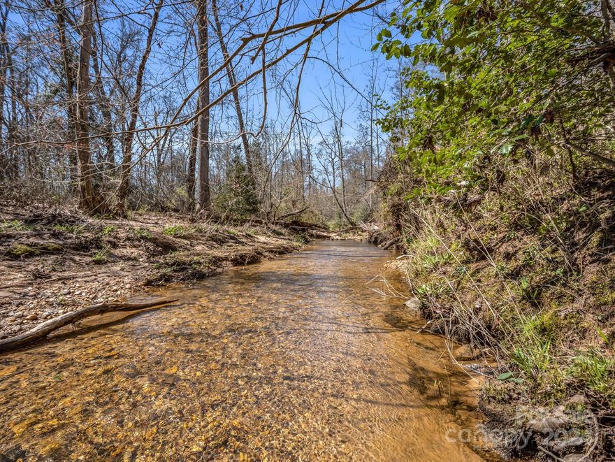 This property boasts a BEAUTIFUL creek that winds its way along the back end, offering a serene and picturesque setting for you to enjoy. A pathway provides easy access to the creek's banks, perfect for relaxing strolls or simply unwinding by the water's edge. With three lots totaling around 8 acres, there is ample space for various building possibilities, whether it be a single-family home, cabins, or other structures to suit your needs. Additionally, the presence of a manufactured single wide on the property offers immediate accommodation options while planning and constructing other buildings or improvements. A previous owner had 2-3 manufactured homes on the property (removed prior to the current owner's purchase). Seller was told there are three septic tanks, however, only two have been discovered and one is connected to the manufactured home. Really lovely property with lots of options!