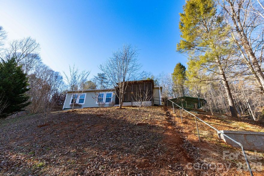 3 bed, 2 bath 2014  doublewide with a beautiful mountain view in private Old Fort. Major updates in 2025, including a new roof, retaining wall, and added structural support. Seller reports no damage from Helene, these improvements were made for added peace of mind. Come see the view for yourself. A great chance to enjoy quiet mountain living at an affordable price. NO HOA TO ENFORCE RESTRICTIONS PER SELLER.