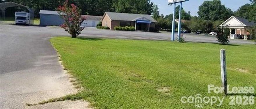 Former Used Cars Lot building with 1.48 acres large paved parking lot and 2 storage buildings remain.  Office space has main lobby area, several office spaces, ample storage and 1 full bath with shower and 1 half bath in front lobby. Some furnishings and contents remain.  Start your business up here!