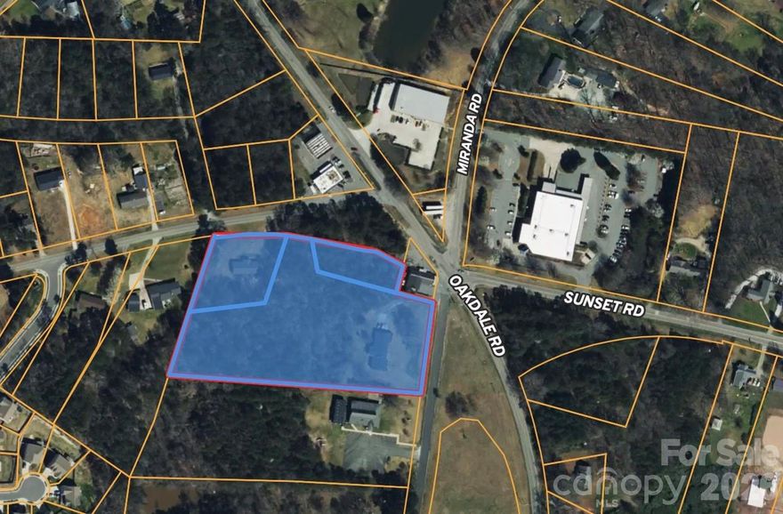 Three adjacent parcels make up the 4.79 acres located at intersection of Oakdale Road, Miranda Road, Sunset Road, and Simpson Road. The Policy Map from the 2040 Comprehensive Plan designates PID 03308309 as the Neighborhood Center Place Type and the other two parcels as the Neighborhood 1 Place Type, which allows a variety of commercial uses. NC DoT has plans for a roundabout to be built at this intersection.