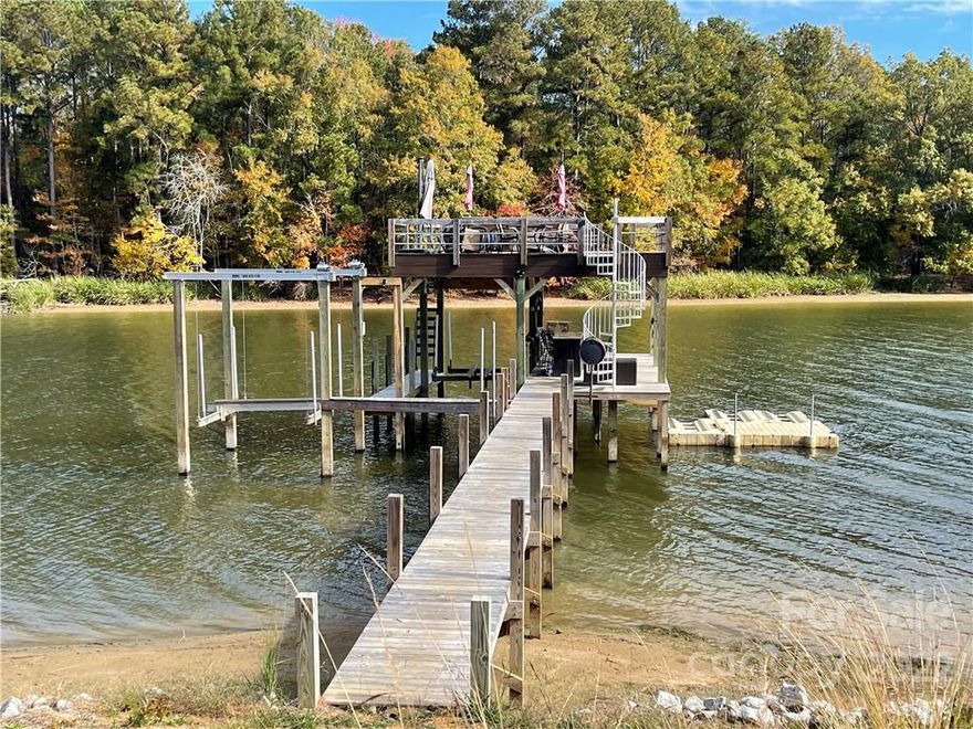 Your dream home building lot is available in The Woods of Molly Creek subdivision on Lake Wateree with the most expansive dock you can imagine! Water and electricity are already in place. The seller has graveled the circle drive, done extensive grading to tier the lot and dug out for a walk-out basement floor plan. The two level dock has 2 boat lifts, 2 jet ski ports, a covered lounge area with a bar and custom grill. And that's just on the bottom! Once you go up the spiral staircase, there is a sun deck with another bar and golf driving pad. The approximately 240 feet of shoreline is stabilized with a rip rap wall. There is a natural view with no homes across the cove and deep water. Bring your floor plans and dreams!