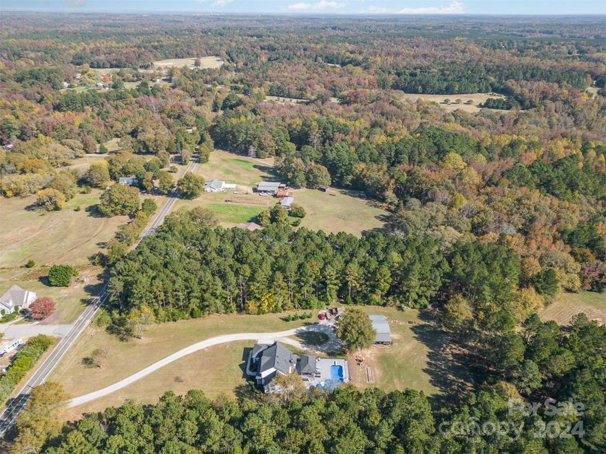 Incredible opportunity to live in a private country setting with over 2 acres, only minutes from I-77,shopping,and 30 min from Ballantyne. This beautiful custom, upgraded, well maintained home features an 
in -ground lovely salt water pool with slide,newer liner, AND an amazing new pool house which includes a refrigerator & bathroom!(2024) The serenity and peacefulness of this private spacious lot and beautiful home is unique. Gorgeous covered new deck overlooking the pool using high end Timberline composite deck boards (2024) & an additional open deck as well. This property offers a pole barn/workshop with garage door (16X32) with water & electricity, cost 50K. Two covered areas attached to pole barn (24X40 & 16X40) Freshly painted exterior windows, all shutters, all columns, garage door, front door.  NEW roof, 24K whole house generator, tankless water heater and bonded termite warranty. New gutters & downspouts 2024 and more! Walk-in huge attic (34x15) gives this home ample storage.