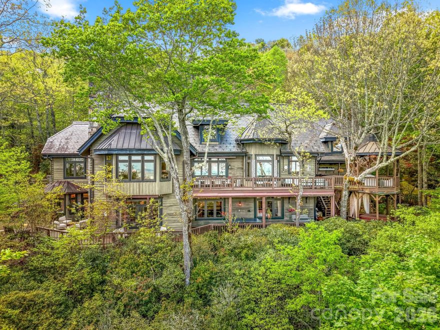 Some homes are impressive; others are unforgettable. Nestled within the highly sought after Lake Toxaway Estates, in the heart of the Blue Ridge Mountains—where the Land of Waterfalls meets refined luxury—this private sanctuary feels like a destination few will ever discover. Inspired by the charm of an English countryside lodge, the home blends old-world character with modern turnkey elegance featuring handcrafted details, rich natural textures, and spaces designed to feel warm, collected, and entirely one of a kind. Perched atop a private ridge, mornings begin above the clouds—with sweeping long-range mountain and lake views where breathtaking sunrises stretch for miles. Inside, every room tells a story—from soaring wood ceilings and a dramatic stone fireplace to a charming chef’s kitchen, intimate gathering spaces, a statement wine feature, and a billiards lounge with wet bar. The main level is set up perfectly for entertaining and everyday living with rich oak hardwood floors, an office nook, formal dining room, and bedroom ensuite. The handsome gentlemen's retreat is sure to impress with a beautifully carved English wood bar. The floorplan easily offers the option to add an elevator allowing access to all three levels. The terrace level, featuring 10' ceilings, includes two additional bedroom ensuites, a second wood-burning fireplace, walk-in closets, and a home gym complete with another full bath and sauna. On the upper level, you'll discover the loft area with additional spectacular views and another private bedroom ensuite. The stoned entry leads to an easy circular drive and two car garage with separate access to the large, finished living space above!  And just when you think you’ve seen it all, the property continues to unfold—hidden outdoor spaces, wrap around decks on two levels, a gazebo suspended above the trees complete with a hot tub, moss-covered stone pathways, a tranquil waterfall, and a fire pit made for evenings that turn into memories. Completely private, yet moments from hiking trails and Lake Toxaway Country Club amenities including the country club, golf course, marina, and the Greystone Inn. This is more than a home, it is a legacy retreat. Purchase of this property can include a transferable boat dock and available Glastron GXL 235 powerboat. Membership to Lake Toxaway Country Club is through application and availability.