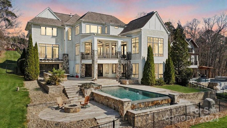 Your own private haven! Experience lakeside luxury in this magnificent custom-built three-story home boasting expansive water views throughout! Step into the grand foyer w/ a stunning three-story floating staircase, setting the tone for the opulence that awaits. Bathed in natural light from floor-to-ceiling windows, the open floor plan w/Chef's style kitchen, dining room, and the vaulted great room is perfect for entertaining! The vast laundry room/office is a must-see! The main-level primary suite with a private balcony, & a sumptuous en-suite bath complete w/ a TWO-STORY CLOSET awaits you. The third floor boasts a library, 3 generously sized bedrooms & a bonus room. The lower level features a rec room, family room, bar, & flex space, w/ over 600 sq ft of storage. The expansive patio provides an enchanting setting to unwind & entertain, overlooking the saltwater infinity pool w/ imported Italian travertine, putting green & outdoor kitchen. Embrace the LKN lifestyle! Paradise awaits!