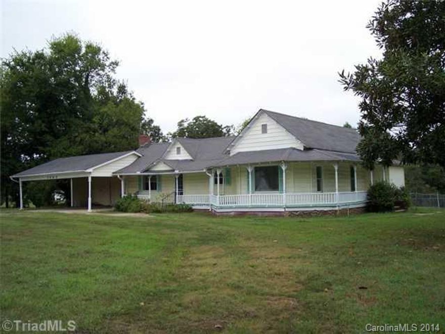 Vintage 1920's farmhouse with lots of peronality. Wrap around porch, side porch, circle drive, 3acres, outbldgs, fenced back yard, 2 car carport. Wood insert in liv rm, fireplace in MBR has not been inspected for use. Room listed as office has large closet and could be 4th BR or add a bath for the master. What I call a den is an area off the liv rm and kit that leads to the bathroom, laundry and & 2 bedrooms. It also has a door to backyard. Off  the kitchen is an enclosed porch. House needs TLC.