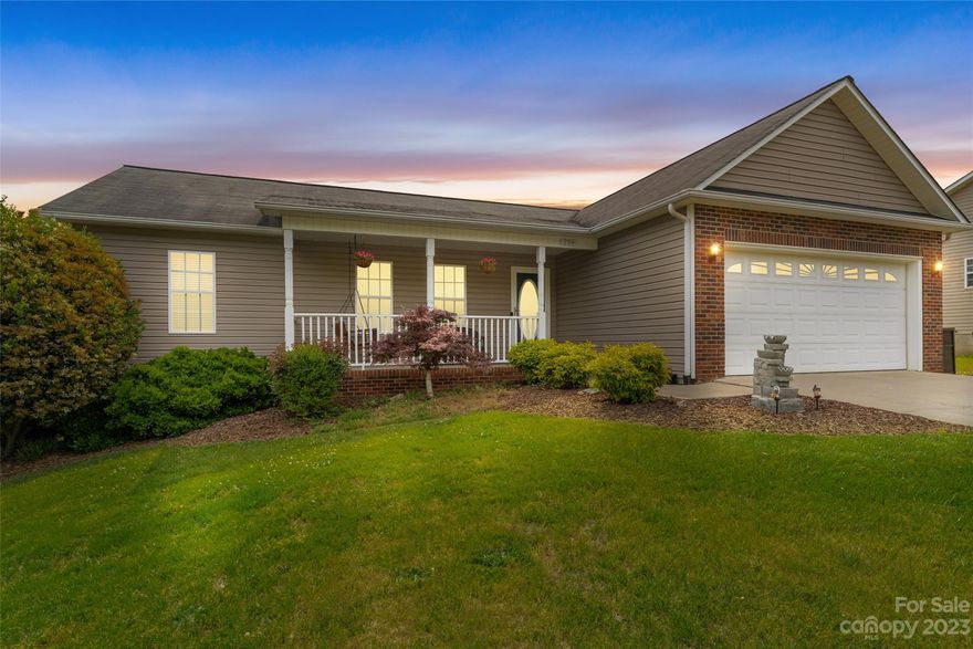 Perfect move in ready, one level home, with two car garage, and rocking chair front porch! This home offers low maintenance living with private backyard, updated engineered hardwood floors, great flow for entertaining, and is in excellent turnkey condition. Located in the Pine Meadows Subdivision with quick access to I40, Hwy 70, Hickory, Morganton, Valdese and Lenoir. Three bedrooms and two full baths with an open living room and kitchen area as well as a large deck overlooking a private backyard and built in fire-pit! A spacious two car garage and exterior uplighting make this home the perfect fit for all your needs! Freshly painted interior and deck in 2020. Don't miss this wonderful home! Easy access to view.