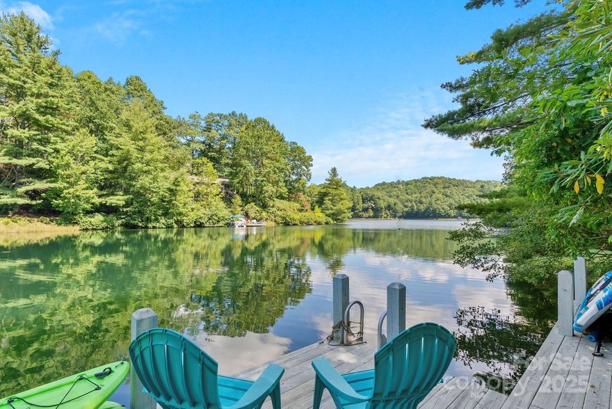 Welcome to your mountain, lakeside escape… situated on a gentle, .87 acre lot on Lake Ticoa, Connestee’s most serene lake. With 300' of shoreline, wooded privacy and beautiful lake views are the backdrop to life here. This Jerry Brown built home exudes quality and quiet elegance. Step inside to find sweeping water views that greet you at the door and wrap around this lovely home. The great room delivers soaring ceilings and a wall of glass facing the lake, bringing ever-changing light & views into the home. Wood floors, an open floor plan and the propane fireplace make the expansive space cozy & welcoming. The adjacent sunroom boasts 3 walls of windows with lake & forest views and serves as additional lakeside living & entertaining space. The cook's kitchen boasts a propane cooktop, a huge prep island, granite tops & tons of storage. Relax in the gracious, main-level primary suite, which is situated at the far end of the house for additional privacy. This home was built for entertaining... guests will love spreading out in the lower level, which is decked out with its own living room with fireplace, 2 guest rooms, baths & kitchenette. With meandering paths around the house and through the woods and an easy path to the lake, the grounds are lush and easily navigable. Dock your boats & water toys at the private dock and enjoy life with Lake Ticoa as your playground. The 500sf workshop / temperature-controlled storage or hobby room, short & level driveway & location within the community are bonuses! Residents new to Connestee pay a one-time $13,500 amenity fee at closing to enjoy amenities such as:  clubhouse, 2 restaurants, golf, state-of-the-art fitness center, pickle ball, tennis, bocce, swimming pool & miles of hiking trails.