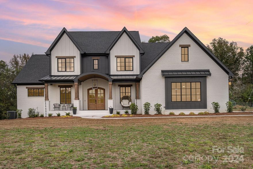 Experience ultimate privacy and luxury in this custom-built 2023 home, nestled on over 22 acres. The painted brick and fiber cement exterior offer durability and modern appeal. Inside, enjoy quartz & granite countertops, white oak flooring, & casement windows throughout. The chef’s kitchen features custom cabinetry, a copper farmhouse sink, & high-end appliances. A huge walk-in pantry is cleverly hidden behind a door that blends with the cabinetry, plus an interior access point to the garage for easy unloading of groceries. The main-floor primary suite offers a clawfoot soaking tub, electric fireplace, walk-in shower with dual shower heads, and custom finishes. The expansive full basement, with a separate entry, includes a full kitchen, 2 bathrooms, a bedroom, a gym, and three additional rooms—ideal for multi-generational living. Upstairs, find 4 spacious bedrooms, 2 bathrooms second laundry room, & walk-in storage spaces. Privacy, style, and functionality—this home is a must-see.