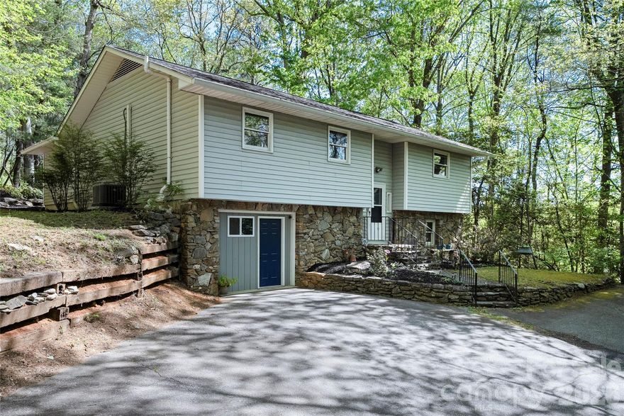 Welcome to 84 Chisholm St. This property offers space, flexibility and a peaceful wooded setting on approximately 1 acre, just minutes from downtown Saluda. This three-bedroom, two-and-one-half-bath split-level residence features 2,331 square feet with hardwood, luxury vinyl and carpet throughout the main living areas. Kitchen was recently updated and new paint in main bathrooms.  The primary suite is an oasis that includes an expansive adjoining sitting room that can serve as a home office, study or private retreat.  Step outside the primary bedroom to enjoy the Aqua Living G6 Tranquility hot tub surrounded by mature oak trees and natural privacy.  The finished basement provides an ideal secondary living space for entertaining, movie nights or game-day gatherings. Relax on the back deck with a cup of coffee or grilling out with family. Laundry is located in the finished basement with an additional hookup available in the main level sitting room. Built in 1986, this home combines comfort and versatility with easy access to Saluda’s restaurants, specialty shops, art and music venues, plus nearby outdoor recreation including hiking, biking and mountain adventures.  Come discover what 84 Chisholm St. has to offer.