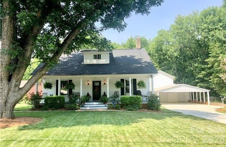 Rare opportunity to own one of Matthews oldest homes.  This renovated 1901 bungalow is the perfect blend of gracious and modern living in the heart of Matthews. Offering the character of an older home with the conveniences of new construction, this home maintains it's historic charm. Featuring a rocking chair front porch, large windows, beautiful millwork & site-finished hardwood floors throughout, this home is steeped in history. The four fireplaces feature exposed brick, floor to ceiling. Formal dining room/library w/corner fireplace. Inviting family room opens to breakfast area & kitchen. You will feel welcome as soon as you enter this space. The main level master suite is an owner's retreat. Detached 3 car garage with finished bonus room and full bathroom. Large deck & huge carport is the perfect space for hosting large gatherings. Completely rebuilt from the studs out in 2014, this home has been restored to it's former glory on one of the loveliest streets in downtown Matthews. Perfect location within walking distance to greenway, schools, parks, restaurants and shops.