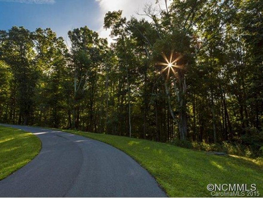 Wonderful wooded lot in Beautiful Grand Highlands. Has electric and city water. Homesite features incredible privacy while being close to the amenities inside the gated community. Property borders hiking trail system. Winter View of Bearwallow Mountain.