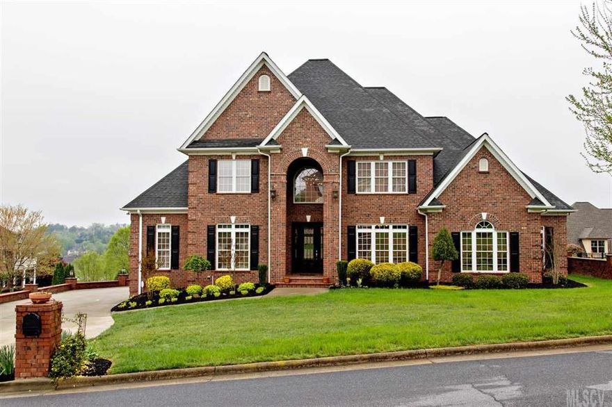 Custom built home with features galore plus panoramic lake view! Main level boasts, two story great room, formal dining room, kitchen w/eating area, elaborate master bedroom & guest room w/private bath. Wine cellar in enclosed basement area. Upper level has 3 BR's, den, recreation room, open balcony & 2 full bathrooms. Kitchen is enhanced center island, SS appliances w/warming drawer, microwave, DW, Convection oven, range & pantry. Extensive moldings throughout, wood flooring in common areas, ceramic tile bathrooms, large walk-in closets, spot lighting, 10' ceiling on main level, arched entries, central vac, security system & more. Master BR has sitting area, bath w/double vanity, corner jetted tub & separate shower. Guest bedroom on main level has private bathroom. Surround system in upper level den. Enjoy the view from the outdoor patio while entertaining your friends. This is a must see home as words can't describe all the custom amenities. 4 car garage & level corner lot.