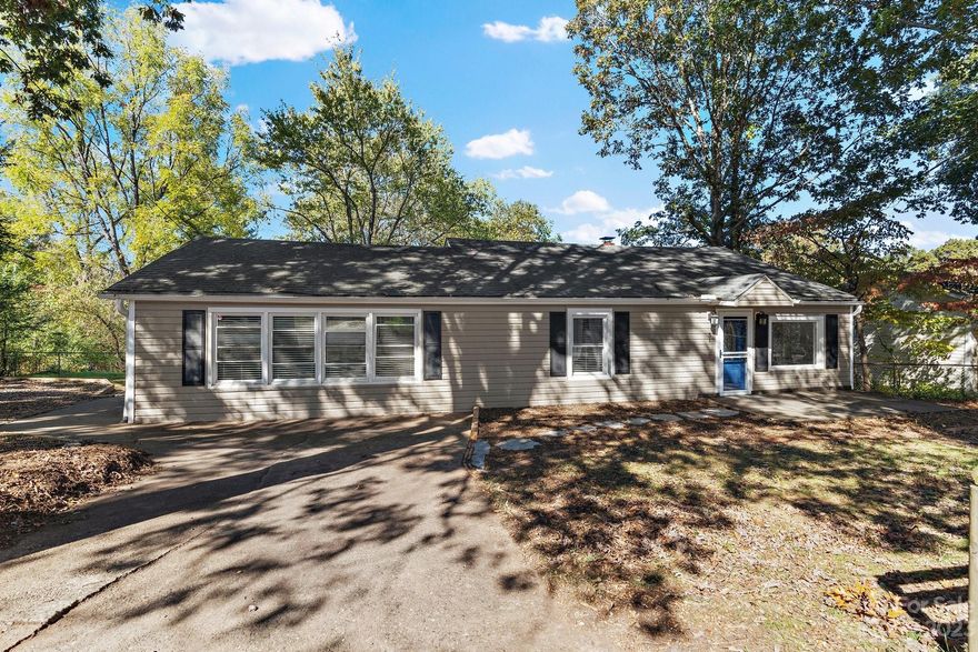 Discover the promise of endless potential in this charming Woodfin home. Boasting 3 bedrooms and 2 baths, this home is a haven of bright possibilities.

Step inside to find a welcoming family room with a substantial bookshelf, perfect for your  treasures. An entertainment room adds another layer of versatility, while the kitchen, complete with a breakfast bar, will inspire your inner chef. Share meals in the adjacent dining room, creating cherished family moments.

Outside, you'll be delighted to find a rare, expansive, fenced-in backyard with a fireplace and an outbuilding. It's the ultimate canvas for your outdoor dreams, ideal for family gatherings or entertaining guests.

Located just moments from downtown, this residence offers the convenience of urban living while feeling tucked away. Embrace the potential of this remarkable property and make it your own.