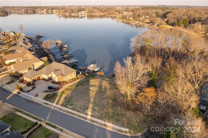 Incredible opportunity to own a beautiful lake lot in one of Lake Wylie’s most luxurious communities, Joslin Pointe. With a beautiful covered dock already in place, complete with a boat lift, two personal watercraft lifts, and ample storage, it offers convenience and luxury right from the start. The PVC-planked dock provides extensive long-range views of the lake and is undoubtedly a fantastic feature, perfect for enjoying the serene beauty. Upon purchase, being able to immediately enjoy the pleasures of lake living while planning and building a dream home is a significant advantage. The gated community of Joslin Pointe, with its clubhouse, pool, and stunning architecture, adds to the allure of this opportunity, with picturesque scenery surrounding you. Given the unique features and desirable location, it's no surprise that this opportunity won't last long. For anyone seeking the ultimate lakefront lifestyle, this beautiful waterfront lot in Joslin Pointe is the perfect choice!