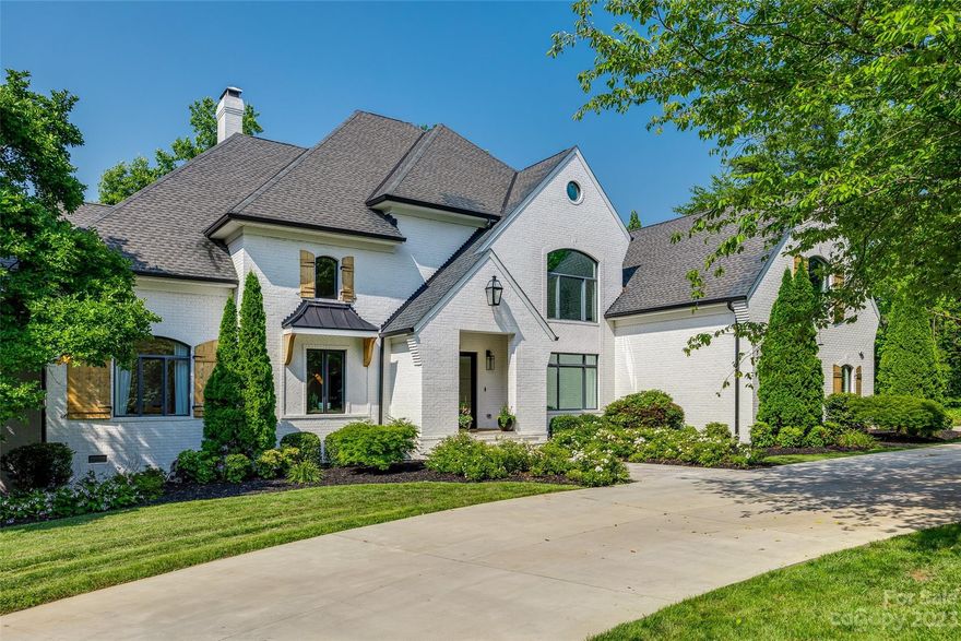 Incredible opportunity to own this Axios Charlotte and QC Exclusive 2020 Home of the Year! Beautifully positioned on 1.7 acres in the tranquil community of Patrick's Purchase, this waterfront home is an entertainer's dream come true. Renovated down to the studs this home offers almost 9,000 sq. ft of heated living space complete with its own indoor racket/basketball court, heated salt water pool and spa. Double glass doors welcome you as you enter the two story foyer with curved staircase trimmed in elegant white and black tile. Custom high-end finishes greet you in every room and compliment the home's neutral color scheme. Stunning gourmet kitchen with oversized T-shaped eat-in island, ILVE Majestic range and Viking wall ovens. Relax on the new second story deck overlooking mature landscaping & gorgeous Lake Norman views. The gazebo, pier and dock with two boat lifts offer the perfect setting to watch the sunset.