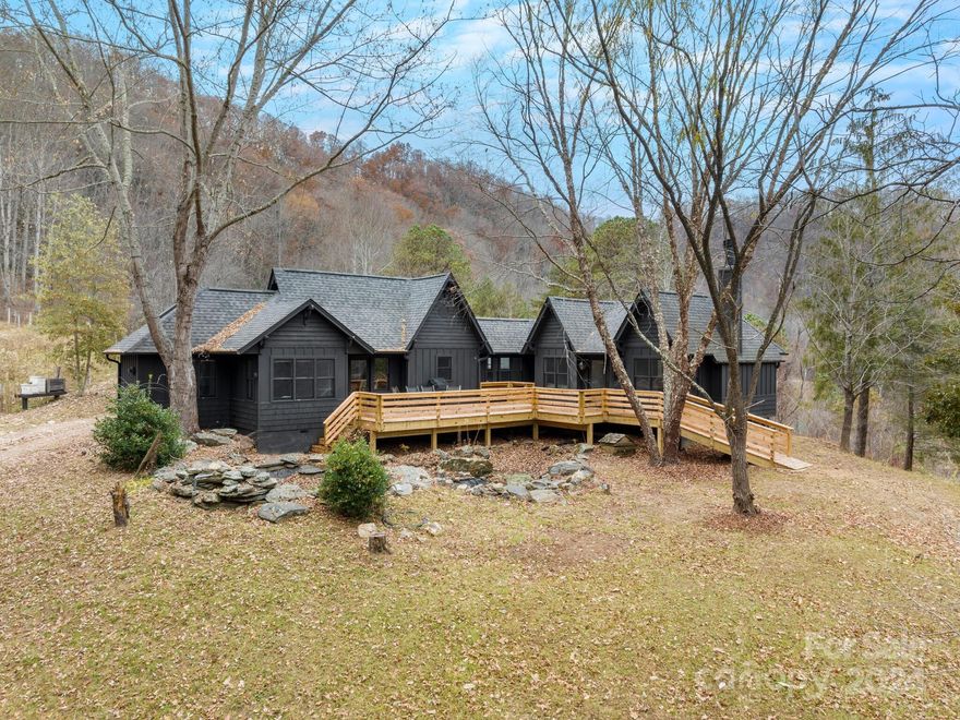 Indulge in the serene beauty of this meticulously crafted 2-bed/2-bath cabin nestled on over 9 acres of secluded bliss. Reimagined with a blend of wood and cedar shake, this retreat boasts Thermador and Jenn-air appliances, embodying unparalleled quality. Unwind by the fireplace in the cozy sitting room or soak in nature's symphony on the rear porch overlooking a tranquil water feature. Cultivate your own garden oasis or explore the potential for a mini-farm. Surrounded by rhododendrons and flourishing dogwoods, this haven offers a harmonious blend of luxury and natural splendor.