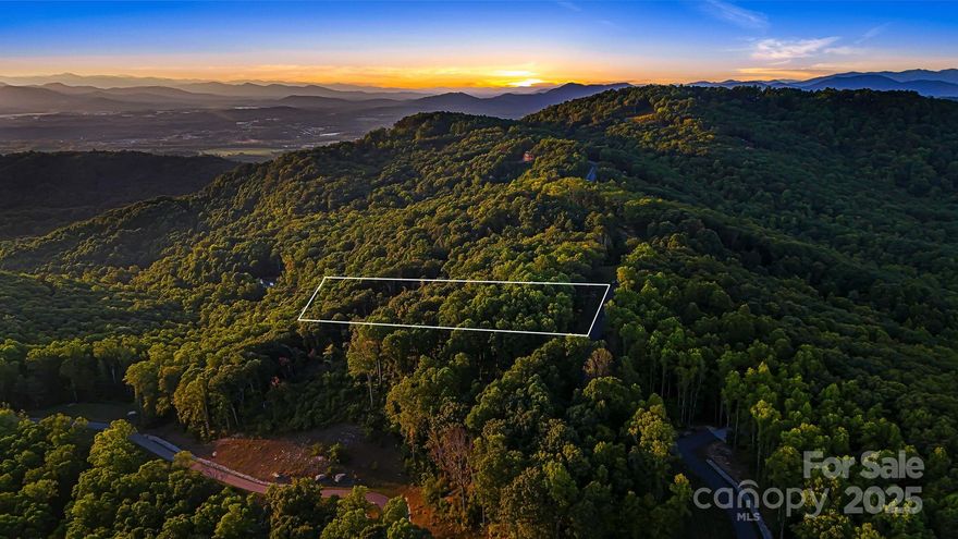 Immerse yourself in the beauty of Lot 68 Mountain Grove Lane. This unique 3.19- relatively flat homesite offers
breathtaking, expansive, long-range mountain views. Spend your evening taking in the awe-inspiring mountain sunsets from your home. Step out your front door and into nature. This unique homesite offers easy access to the Featherstone Path and Laurel Run Trail. Couch Mountain provides an idyllic lifestyle. Residents can access two community gardens, a greenhouse, an apiary, and the impressive 138+-acre Nature Preserve. The preserve is a nature lover's paradise, featuring over 4 miles of hiking and biking trails. This location is situated between Hendersonville and Asheville, allowing convenient access to the mountain towns' charm and beauty.