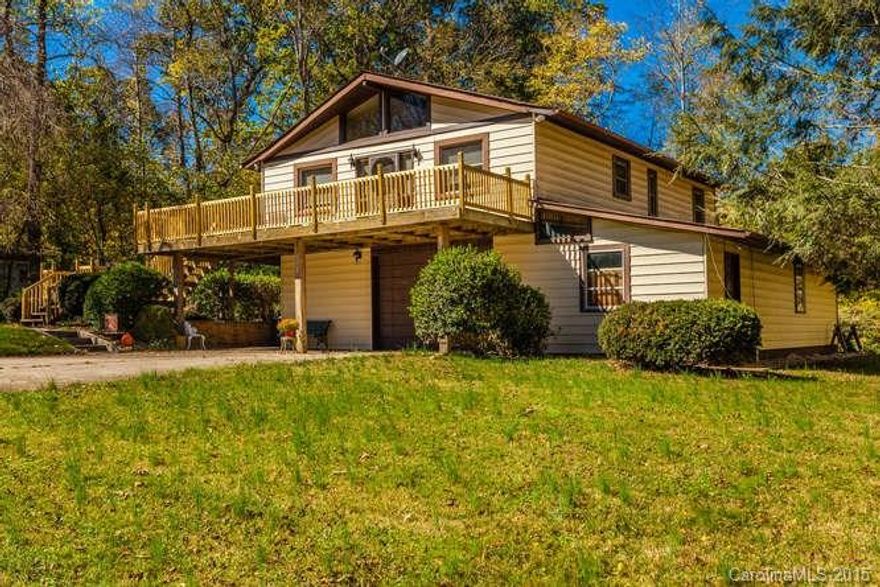 Private, with 8.15 acres just off I-40. Minutes to Asheville or Black Mountain. Great development potential with frontage on Old US 70 and Old Patton Hill Rd. GIS shows a MSD connection at the corner of the property.  Property has well and city water is now at the edge of the property. Would also make wonderful private home with room to garden and play. Detached 2 car garage/workshop. Basement also has an attached 538 attached workshop in addition to the normal basement area. Large flat yard.