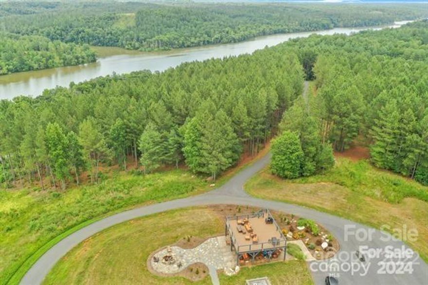 This property has a stunning view of both Mountain & Lake View, a quiet community, your lot is fully serviced with water and sewer, and underground utilities. Build your homesite on this .85 acre semi-cleared, with a gentle slope. This lot is exceptional on high ground, with a stunning, vista view of the lake and mountain range, including Table Rock; located on a small loop; adjacent to the Community Pavilion, which offers a grill, fire pit area with seating, picnic tables, restrooms, and an upper deck to take in the water, mountain, and amazing sunset views. This community would be great for someone who wants to build a full-time forever home, or a vacation home for that perfect get-away.