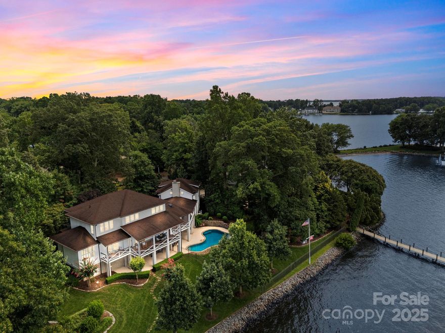 Welcome to 19029 Brigadoon Place. Picture-perfect sunset view home with timeless curb appeal and over 220 feet of prime waterfront living on the main channel. This 5 bedroom, 5 1/2 bath home offers an open floor plan with luxury finishes throughout, including hardwood floors on the main, upper level, and travertine tile in the basement. A light-filled kitchen flows into the welcoming great room with a dramatic fireplace setting the stage for relaxed evenings. Main-level primary suite offers stunning lake views and a spa-like bath. The finished basement adds flexible living space, while a 3-car garage, pantry, drop zone, home office, and two laundry rooms enhance everyday living. The rear yard provides an elegant backdrop for year-round living with covered porches featuring mahogany flooring, an in-ground pool, an outdoor fireplace, and sunset views of Little Mountain. A private dock, exceptional lot, and walking distance to The Peninsula Club...ensure this is the one!!