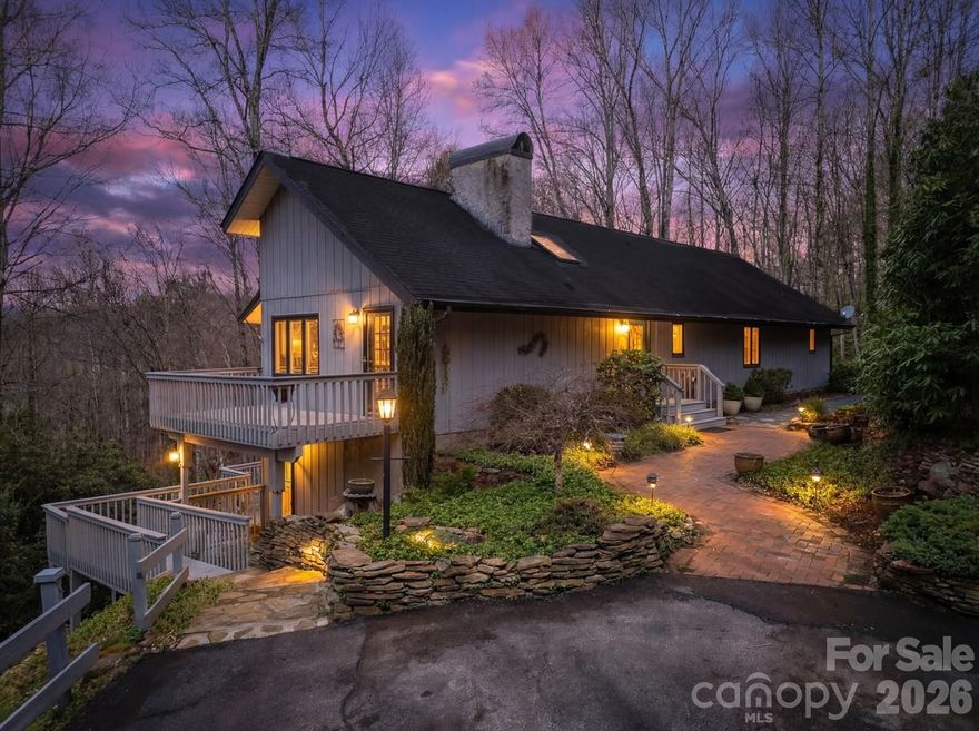 Tucked into the woods in a beautiful setting, just minutes from downtown Brevard, this private mountain retreat offers the perfect blend of nature, comfort, and adventure.  The setting immediately feels special, quiet, secluded, and connected to nature.  Step inside and you're greeted by soaring vaulted ceilings, dramatic exposed beams, and a stunning floor-to-ceiling stone fireplace that anchors the main living space. Large windows bring the outdoors in, filling the home with natural light and forest views in every direction.  The spacious layout provides multiple gathering areas while still maintaining a warm, inviting feel. The kitchen features solid surface countertops and ample cabinetry, perfect for everyday living or entertaining.  Outside, the experience truly becomes something rare. A network of private nature trails cultivated by the owner winds through the property, leading you across a charming wood bridge on a peaceful creek.  Whether it’s a morning walk through your private wooded trails or an evening relaxing on one of the many decks and outdoor spaces, this property offers countless ways to enjoy the peaceful mountain setting. The home also features a backup generator.  It's very clear the owner is meticulous with his notes and maintenance items throughout the home.  Only 10 minutes from quaint, downtown Brevard and 18 minutes from Dupont State Forest which features biking, hiking, and waterfalls!  Don't miss walking the trails on the property where the sign marks them 2/3 way up the drive.  Schedule your showing today to find your dream home in the great Glen Cannon Community!