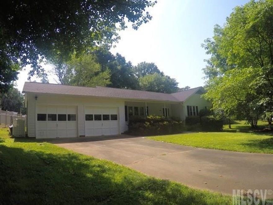 Single level living in Mountain View! This home offers 3 bedrooms, 2 full bathrooms,  sunroom, remodeled kitchen (finish painting not yet complete - should be done 2nd week in June) and bathrooms, custom cabinetry, Corian countertops, double car garage, fenced in back yard, expansive deck, outbuilding, and mature landscaping. Laundry area is located in the hallway (bi-fold doors are in the garage. Seller preferred the curtains currently in place). Master bedroom is complete with private bathroom and entrance to the back deck. Sunroom is not heated or cooled (3 season sunroom - seller utilized space radiator heat during the coldest winter months).