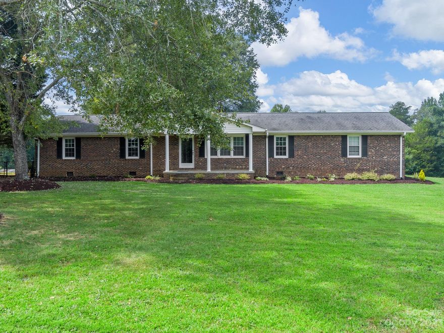 What an awesome property. This brick ranch sits on approximately 3.5 acres in Campobello with a 3 car detached carport. The welcoming front porch invites you to sit a while and enjoy nature and the mature landscaping the property provides.  Step inside the foyer that leads to the large living area on the right. From the living room you will enter the formal dining area leading you into the kitchen that is open to the den for plenty of space perfect for entertaining. In the kitchen there is laminate flooring, Corian countertops with a seamless sink, a built-in electric cooktop range and built-in microwave. The den has a gas log fireplace perfect for those chilly fall and winter nights.  The master bedroom has a full master bath.  The other two bedrooms have laminate flooring and share a bathroom.