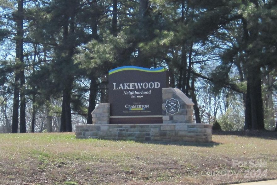 Situated in desirable Lakewood area of fine homes in Cramerton, this home is ready for new owners! 3 bedrooms, 2 1/2 baths, Formal living/ dining rooms as well as den and rear bedroom that have private entrance to screened porch are a complement. Kitchen recently remodeled. Property landscaped with over 300 blooming plants and hardwoods and is vibrant and colorful in the spring! swing areas and trails go around home, 2 1/2 baths!  There are two doggie doors to enclosed small dog run, rear outside entrance to a basement for a wonderful workshop/hobby train room. Tankless gas water heater and dryer adorn this well maintained home. There is a special garage for a newer golf cart and it conveys with home so new owners can take Goat Island Park access to downtown Belmont/ Cramerton for eclectic dining and shopping. Close to medical and highways, perfect for commuters! Small town living with city access, seller motivated, Bring offers!