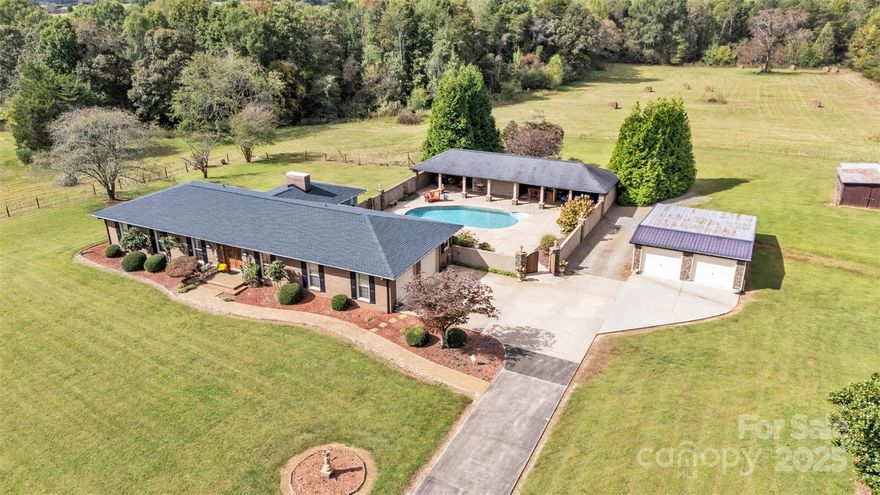 This one-of-a-kind property features 30 ACRES, BARN, fenced pastures, POOL w/ Outdoor Kitchen, bathroom, pool room & Cabana Bar, Beautiful home w/ 3BR 2BA & SUNROOM! Large attached 2 car garage plus a detached garage (24X36)! Recently surveyed to confirm the 30 acres, the property includes multiple fenced pastures ideal for cows, horses, or other livestock, with a stream running along part of the back property line. A barn offers two stalls, water access, a hayloft, and an additional bay, complemented by a detached garage for extra storage or workspace.
The inviting 3-bedroom, 2-bath home offers approximately 2,235 heated sq. ft. of thoughtfully updated living space. Originally built in 1980, the home has been beautifully updated and offers hardwood flooring, a renovated kitchen featuring stainless steel appliances and granite countertops this kitchen is great for entertaining. Enjoy a formal dining area and a cozy breakfast bar in the kitchen. The heat pump has been updated, and the roof (on home) is approximately two years old for added peace of mind. Step into the stunning sunroom overlooking the backyard and pool area — a true retreat designed for relaxation and gatherings. The incredible outdoor entertaining space features a full kitchen, covered dining area, cabana bar, and serving window. The sparkling pool (with an updated liner) includes an outdoor bathroom and pool house for convenience. The sellers have comfortably hosted gatherings of 40+ guests, making this the perfect venue for celebrations both large and small. The property is currently enrolled in farm-use tax status for reduced yearly property taxes; a new buyer may continue this benefit if they qualify (agent has tax office contact details for verification). A recent professional survey and plat are available for review. This remarkable property truly has features not often seen together — acreage, updates, and exceptional outdoor living!!