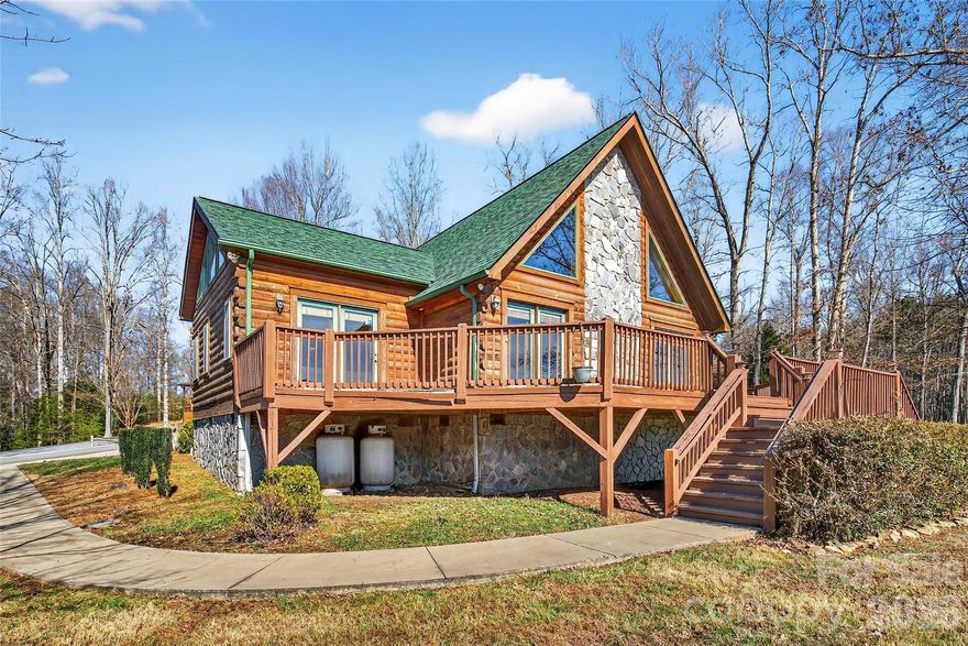 Been looking for a classic mountain log cabin without the maintenance? Wanting a getaway that's still convenient to town, a gorgeous lake and two of NC's best cities? Well, you found it. This one-owner, well-maintained rustic charmer has so much to love: a brand new roof, 3 large bedrooms each with their own attached bath, a stunning floor-to-ceiling gas fireplace, decks all around, 4-inch oak floors, custom molding and trim throughout, stainless steel appliances, Corian countertops and a huge detached garage complete with its own finished (no HVAC currently) space above the parking area. Use it as a workout room, abundant storage, art studio, additional guest quarters - so many possibilities. Need a primary home? The convenience to I-40, Lake James and its state park, the town of Marion and the amazing cities of Asheville (45 min) and Charlotte (90 minutes) make that totally feasible. Need a vacation home that helps pay for itself? She can do that too! Short-term rentals (AirBNB & VRBO) are allowed! Tucked just inside a lovely small gated community, enjoy the benefits of security, a community pool and friendly neighbors all with low HOA fees. A solid, warm and inviting property, she is move-in ready. Bring your own warmth and love - and let's make her a home again.