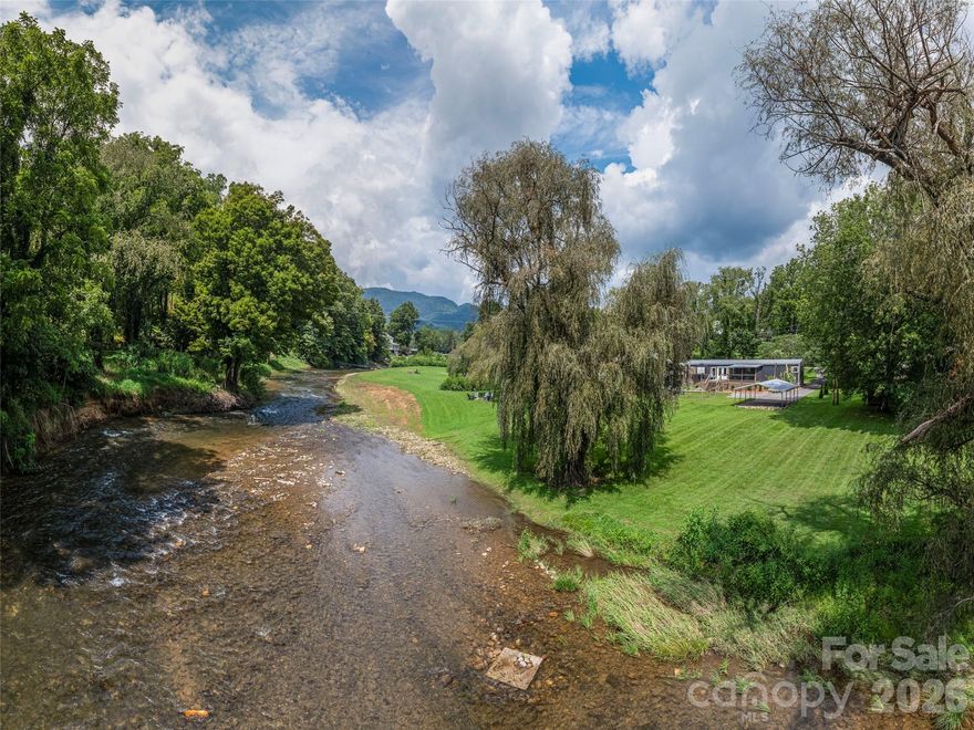 Discover a truly special riverfront getaway on the Pigeon River in Canton! This unique, extensively renovated home is a proven vacation rental success with over 28K in gross rental income for 2025!  Inside, you’ll find custom cabinets, granite countertops, stainless steel appliances, and a spacious split-bedroom layout with a luxurious primary suite. French doors lead from the living room to a serene back deck with river views, a hot tub, and a screened-in lounge complete with bar and TV—perfect for relaxing or entertaining. The fenced backyard opens to your own stretch of riverfront, ideal for swimming or fly fishing for native trout. Whether you're looking for a private retreat or a furnished turnkey investment, this home offers the best of riverside living.