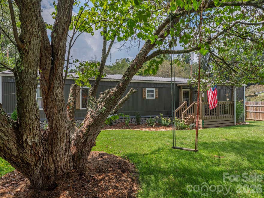 Discover a truly special riverfront getaway on the Pigeon River in Canton! This unique, extensively renovated home is a proven vacation rental success with over 28K in gross rental income for 2025!  Inside, you’ll find custom cabinets, granite countertops, stainless steel appliances, and a spacious split-bedroom layout with a luxurious primary suite. French doors lead from the living room to a serene back deck with river views, a hot tub, and a screened-in lounge complete with bar and TV—perfect for relaxing or entertaining. The fenced backyard opens to your own stretch of riverfront, ideal for swimming or fly fishing for native trout. Whether you're looking for a private retreat or a furnished turnkey investment, this home offers the best of riverside living.