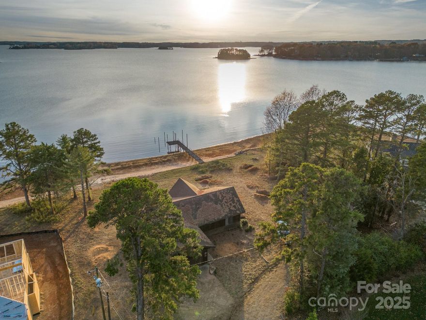 This 0.73 Acre lot has it all! One of the few remaining trophies on Lake Norman on a very private street at the end of The Point with incredible south facing long range views. Over 200ft of unobstructed frontage. Natural and private sandy beach and private boat ramp. Fully permitted 4 bedroom septic (design in attachments) with plenty of room for a dream house and for a pool! No value for current house on property & sold as is. Lot also has a dock but please do not walk on it. Pits on property are from soil testing. Property lines are marked with pink ribbon. Contact broker to schedule viewing.