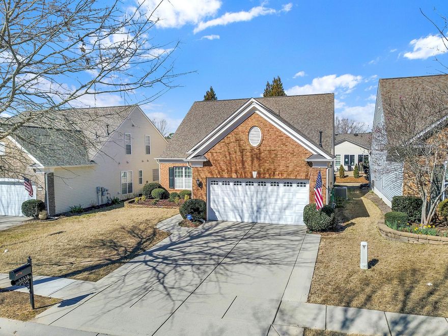 Full brick front, established landscaping w/flagstone garden edging, + paver expanded driveway are just the beginning of this lovely home. Popular Surrey Crest plan features a spacious eat in kitchen w/large island for prep & storage, SS appliances, granite counters, pantry, & large transition window for an open feel. Bright & cheery open  plan offers a gas log fireplace in the great room for the cooler seasons + a separate office w/french doors for home management/flex space. Hardwood flooring & ceramic tile on the main level throughout.  Primary suite features tray ceiling w/fan, dual sink vanity, glass enclosed shower/separate soaking tub. Upstairs enjoy the extra space of a bonus room, full bath, & 3rd bedroom; perfect for visiting family & friends and/or game/entertainment space. Lovely back patio w/hedge surround for privacy & epoxy stone flooring for easy maintenance. Upgrades include whole house surge protector, newer appliances and HVAC, + floored storage above garage.