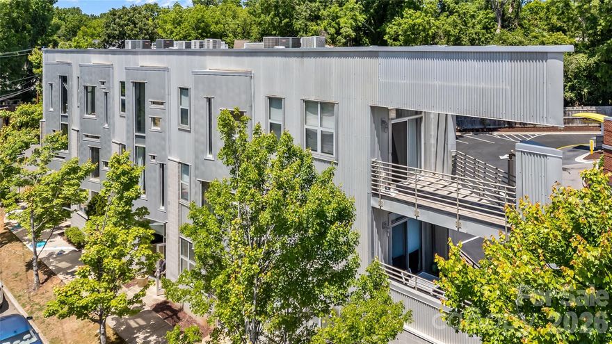 Modern condo living with countless Plaza Midwood restaurants, shops, parks, and retailers at your doorstep! Located in Steelhaus, an iconic building noted for its dramatic and striking architecture, this 1-bed / 1-bath top-floor unit has a desirable open floor plan and sleek, industrial finishes and fixtures throughout. Designed for easy living and entertaining, the kitchen boasts neutral cabinets, granite countertops, an island with bar seating, and stainless-steel accents. The spacious bedroom offers privacy and a generous walk-in closet, while the stylish bathroom has classic subway tile, a vanity with ample storage, and a shower-tub combination. Recent upgrades include a new water heater, a new dishwasher, and a freshly painted interior. The condo includes convenient in-unit laundry, one assigned parking space, and elevator access. Truly unbeatable location for a walkable lifestyle in one of Charlotte's most vibrant and popular neighborhoods!