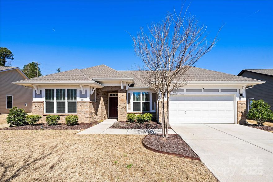 MODEL-LIKE single family ranch in desirable Heritage Hall! Tons of upgrades in this home & meticulously maintained. Kitchen features staggered 42" white cabinets with beautiful, sleek granite, gas cooktop w/ stainless steel microwave/wall-oven, large island w/ seating, ceramic tile backsplash and large pantry. Open to great room w/corner fireplace. Split bedroom floor plan features the Owner's suite at the back of the home, private en-suite bath with dual vanities, walk-in shower w/bench seat & spacious, walk-in closet. Open floor plan with hardwoods on main, formal dining room currently used as a second living area, and secondary bedrooms w/Jack & Jill bath featuring shower/tub combo. Powder room on main adjacent to the living room. Mudroom entry from the garage also features home office w/ cabinets & granite countertops. Professionally landscaped (low-maintenance) exterior with nature views to enjoy from the concrete patio. Two-car garage w/epoxy flooring & fully painted. Must-see!