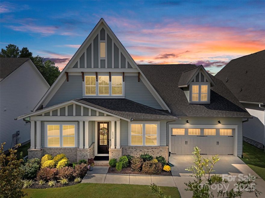 Experience refined living in this elegant, like-new 4-bedroom, 4.5-bath home, offering 3,101 sq. ft. of thoughtfully designed living space. Built with an eye for detail and upgraded features throughout, this residence blends modern sophistication with everyday comfort, creating the perfect retreat for discerning homeowners.

From the moment you step inside, you’ll be greeted by soaring 10-foot ceilings on the main level, rich wood flooring that flows seamlessly through the downstairs living areas and bedrooms, and custom plantation shutters that add timeless charm. The living room centers around a vented gas log fireplace framed by built-in shelving on either side, while 7-inch crown molding runs throughout the downstairs—including the bedrooms—elevating every space with elegance.

The dining room sets the stage for memorable gatherings, featuring 5-foot wainscoting and refined detailing. The oversized laundry room is both practical and stylish, complete with granite counters, a deep sink, cabinetry, and generous storage to keep everything organized.

At the heart of the home, the chef’s kitchen impresses with quartz countertops, an extended herringbone backsplash carried all the way to the ceiling at the custom hood, and a stunning oversized farm sink. Upgraded cabinetry, stacked to the ceiling with crown molding, includes soft-close doors and hardwood drawers, pull-out trays, and full-depth shelving for optimal function. Added LED under-cabinet lighting creates a warm, inviting glow. The kitchen also boasts a walk-in pantry with MDF shelving, an upgraded microwave cabinet above the wall oven, and a large island with seating for four—perfect for casual meals or entertaining.

The bathrooms have been equally upgraded with quartz countertops, elegant tile floors, and tile shower surrounds. The primary suite features a curb-less entry shower with a built-in bench, blending accessibility with spa-like design.

The oversized garage is a dream, featuring a built-in workbench, abundant storage, and a durable poly-coated floor designed for both form and function.

Step outside to your private oasis, where a professionally installed putting green awaits alongside upgraded landscaping and a full irrigation system in both the front and back yards. Relax or entertain on the covered screened porch, designed with a beautiful stone floor, pull-down shades, and a ceiling fan, offering a comfortable place to unwind year-round.

Additional features include an inviting floor plan with four spacious bedrooms, each with its own bath for privacy, and a half bath for guests. The home’s craftsmanship, attention to detail, and upgrades throughout make it stand apart as a true luxury retreat.

Located in a welcoming community of all ages, only one resident needs to be 55+ (does not have to be the buyer). There is flexibility with buyers who are not 55 as there are 5 units or 20% allowed to have residents under the age of 55. This home provides a wonderful opportunity to enjoy a low-maintenance lifestyle without sacrificing comfort or elegance. Blending timeless design with thoughtful upgrades and modern conveniences, this residence is more than a home—it’s a statement of style and sophistication.

The home is built by Saussy Burbank who is well known for building higher end, quality homes with upgraded building materials. Even the insulation is enhanced and the homes are built with airtight sealing techniques to make them more energy efficient along with advanced windows and tightly sealed ducts.