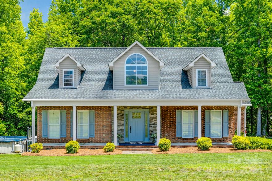 Gorgeous brick 1.5 story home on 5 acres with a 658 square foot guest house nestled in the woods! The main house boasts a beautifully updated kitchen with white cabinets, a backsplash, and granite countertops. The spacious family room leads to a cozy sunroom with white painted brick. Upstairs, you'll find 2 bedrooms and a bonus room featuring new gray vinyl plank floors, a remodeled bathroom, and ample storage. Enjoy the outdoors with a tree-lined backyard, a Trex deck, and a screened-in porch that opens to an above-ground pool with a new cover. The guest house, nestled in the woods, includes a living area, kitchenette with a gas cooktop, bedroom, and full bathroom. The detached garage and carport provide ample space for your vehicles and outdoor gear!