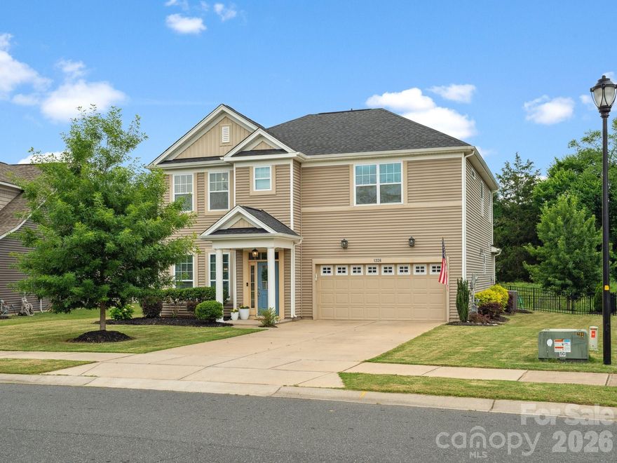 Thoughtfully designed and filled with natural light, this beautifully maintained home offers an ideal blend of space, style, and everyday comfort. Tasteful upgrades throughout include rich wood flooring in the main living areas, wainscoting, and a tray ceiling in the dining room, adding character and architectural interest. The main level features a guest bedroom with a full bath, a formal dining room, and an inviting living room centered around a gas fireplace. The open-concept layout flows seamlessly into the chef’s kitchen, which boasts white cabinetry, a large pantry, tile backsplash, gas cooktop, breakfast bar, statement exhaust hood, and an eat-in kitchen area—perfect for both entertaining and daily living. Upstairs, a versatile loft provides additional living space, along with two secondary bedrooms that share a full bath. The spacious primary suite serves as a private retreat with a large ensuite bathroom and an oversized walk-in closet that conveniently connects to the laundry room. Step outside to a private, fenced backyard, complete with a covered patio offering privacy and a peaceful setting. Ideally located within the neighborhood, the home sits just steps from a green space right outside the front door. Community amenities include an outdoor pool, walking paths, sidewalks, covered community center, and playground, all within the highly rated Clover School District. Conveniently close to shopping, dining, and Lake Wylie, this home truly offers comfort, convenience, and quality in a sought-after location.