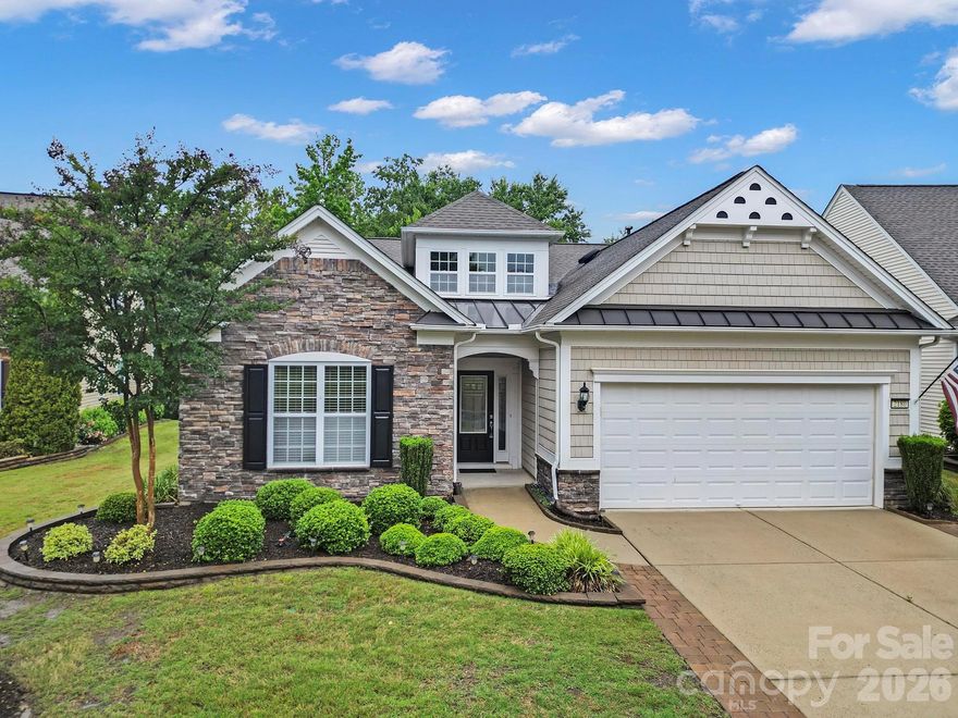 Private wooded homesite! Welcome to this beautifully maintained 3 BR, Vernon Hill model in the sought-after 55+ community of Sun City Carolina Lakes. From the moment you step into the grand foyer, you’ll notice gleaming hardwood floors, elegant wainscoting, and an inviting open-concept design perfect for both everyday living and entertaining. 

The spacious dining and living areas flow seamlessly together, centered around a cozy gas-log fireplace with classic mantel and picture-frame molding accents. The adjacent kitchen offers abundant space to gather, featuring granite countertops, tile backsplash, stainless steel appliances, a large island with breakfast bar seating, and a sunny breakfast nook complete with lighting and a convenient computer niche.

Just beyond the living room, a columned entry leads into a bright sunroom filled with natural light and peaceful views of mature shade trees in the backyard. A private office provides the perfect flex space for working from home, hobbies, or a quiet reading retreat.

Tucked away at the rear of the home, the spacious primary suite features a tray ceiling and relaxing ensuite bath with dual vanities, soaking tub, and walk-in glass-enclosed shower. Two additional generous sized bedrooms are situated near the front of the home with access to a full hall bath, offering comfort and privacy for overnight guests.

Step outside to enjoy warm Carolina evenings on the extended paver patio surrounded by tranquil tree-lined views. Residents of Sun City Carolina Lakes enjoy an exceptional lifestyle with resort-style amenities including golf, tennis, pickleball, indoor and outdoor pools, clubhouse, fitness center, social clubs, and countless community activities. Conveniently located to local grocery, shopping, restaurants, medical and so much more. Additional features include freshly painted main living area, A/C & Furnace - 2020.