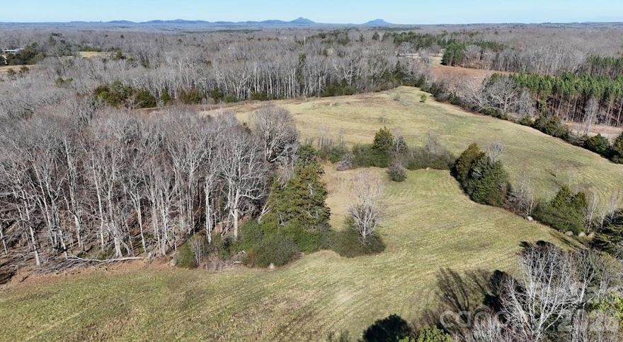 This exceptional 133 acre (+/-) property offers a rare opportunity for investors, developers, farmers, and land buyers seeking long term upside in a rapidly growing market. Comprising of two parcels totaling 89 acres (+/-) and 44.4 acres (+/-) the sellers prefer to convey the tracts together but will consider selling the larger parcel individually. Approximately 42 acres of this listing is open tillable ground that has been planted primarily in wheat in recent years, offering prospective buyers agricultural income potential. The balance of the property is made up of beautiful, mature timber consisting of mostly hardwood, with many stands estimated at 60 to 80 years of age, offering both aesthetic appeal and future timber value.
The property features outstanding access with frontage on three paved roads, including about 1,400 feet along Ramah Church Road on the east and an additional 400 feet combined along Highway 55 West and C.E. Stewart Road on the northwest. This level of access greatly enhances development flexibility and overall value. Two storage barns in good, usable condition are already in place, and Rocky Branch Creek originates on the property and flows year round, adding natural beauty without significant floodplain limitations that would restrict development.
A home exists on the tract but is in need of major repair and is considered to have no structural value, with zoning reflecting land value only. What truly sets this property apart is its strategic location just 10 miles from Two Kings Casino, the largest economic driver this region of the Carolinas has ever seen. With growth, infrastructure, and demand expanding outward from the casino corridor, this property stands out as a strong hold for appreciation, development potential, agricultural use, or recreational ownership. Whether your vision is investment, subdivision, farming, timber management, or a legacy land purchase, this tract delivers size, access, income potential, and location in one impressive package.